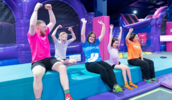Group of children raising arms in inflatable play zone at Oxygen Activeplay birthday party.